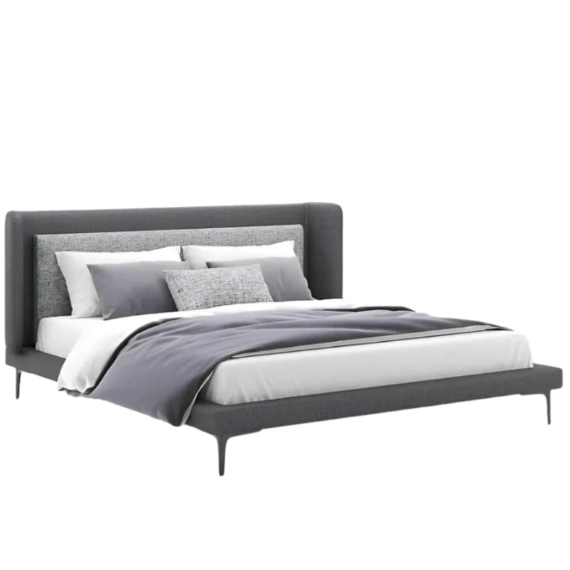 Elsa's bed features a sleek, upholstered headboard and a low-profile base.
